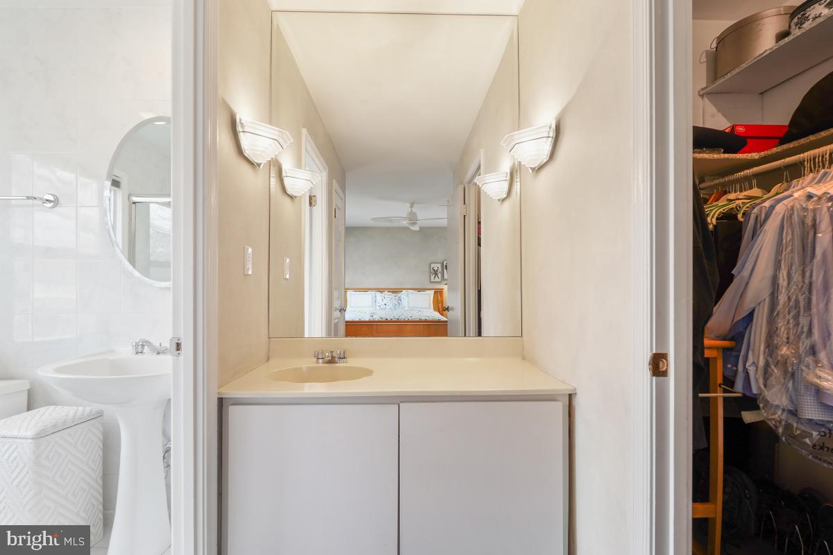 7802 Ivymount Terrace Potomac, MD 20854 - Photo 25 of 51 a bathroom with a bathtub sink and mirror