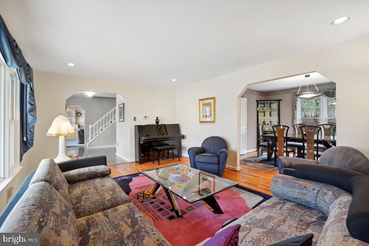 7802 Ivymount Terrace Potomac, MD 20854 - Photo 7 of 51 a living room with furniture a red lamp and a large window