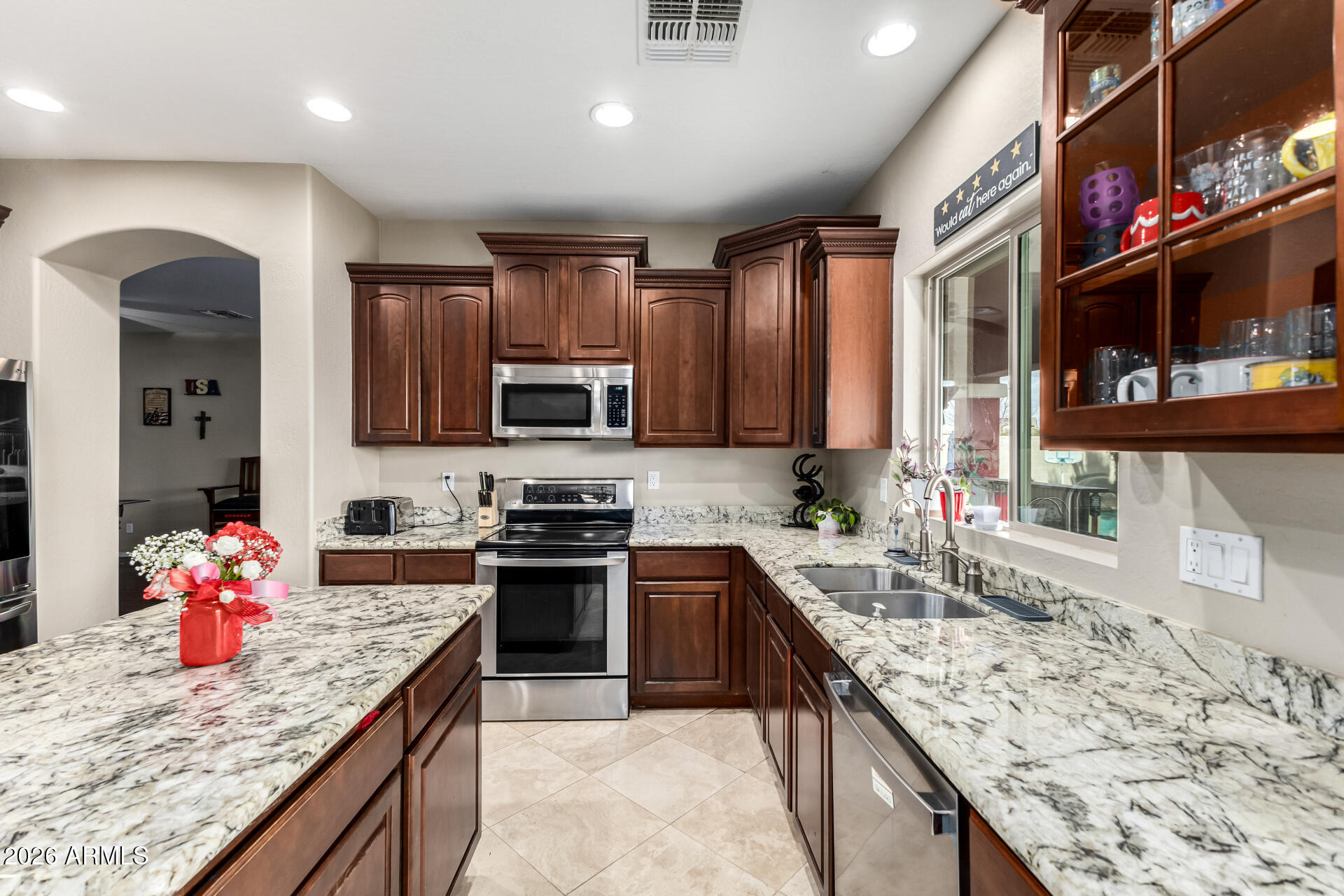 24541 Plum Road Florence, AZ 85132 - Photo 15 of 47 a kitchen with stainless steel appliances granite countertop sink stove and cabinets