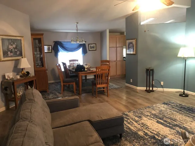a living room with furniture a window and a chandelier