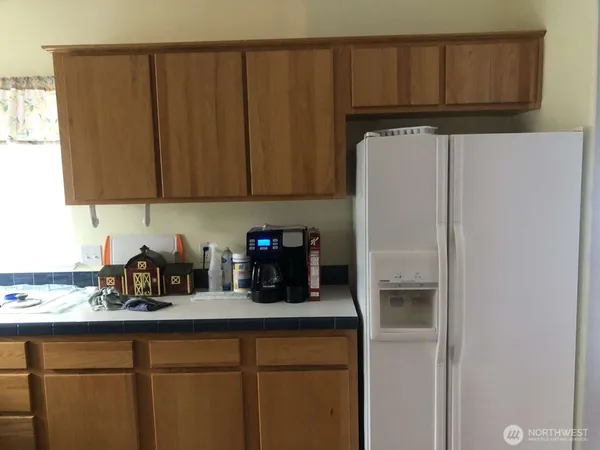a kitchen with a refrigerator and cabinets