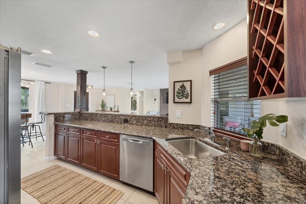 4696 Pompano Street Placida, FL 33946 - Photo 9 of 23 a kitchen with granite countertop a sink and a stove
