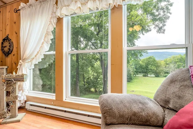 a view of a bedroom with a large window and bed