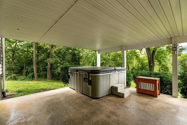 a view of a porch with furniture and garden