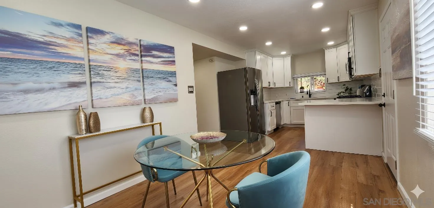 8587 Alpine Avenue La Mesa, CA 91941 - Photo 4 of 15 a kitchen with stainless steel appliances kitchen island granite countertop a refrigerator a stove a sink dishwasher with a dining table and chairs