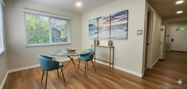 a view of a dining room with furniture and wooden floor