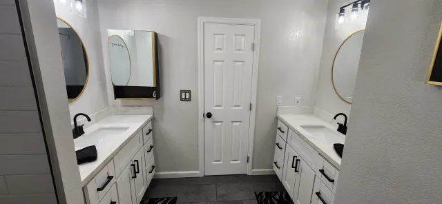 a bathroom with a sink a mirror and a shower