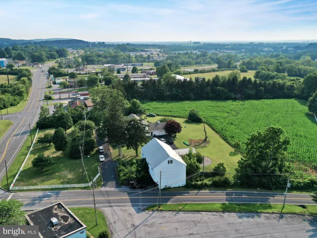 an aerial view of a house with yard