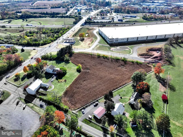 an aerial view of a house with a yard and lake view