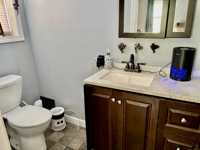 a bathroom with a sink a toilet and mirror