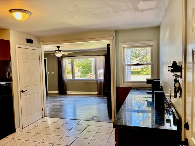 a view of a hallway with wooden floor and windows