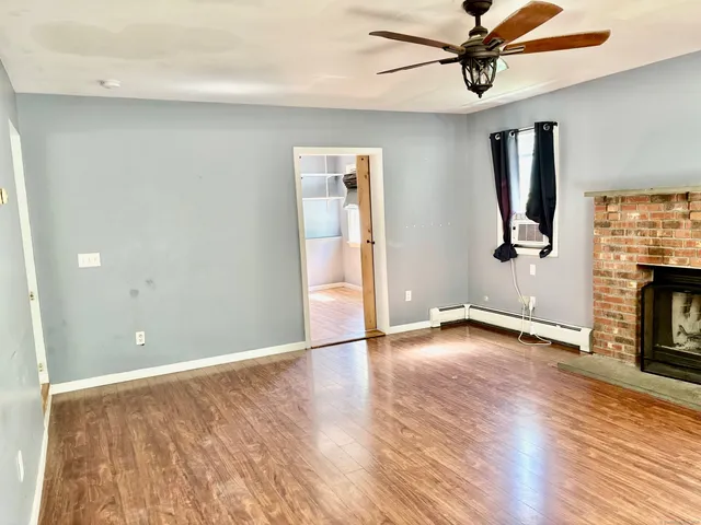 wooden floor in an empty room with a window