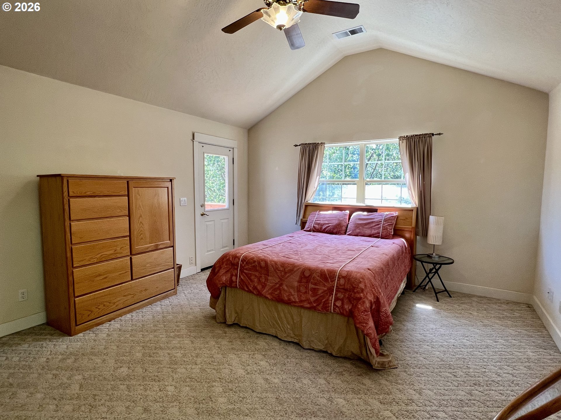 28544 Crow Road Eugene, OR 97402 - Photo 26 of 48 a spacious bedroom with a bed and a chandelier