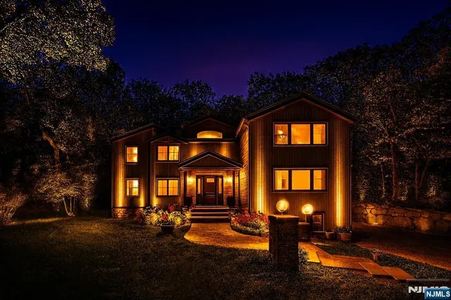 a view of a brick house with a swimming pool next to a yard