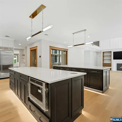 a bathroom with a toilet sink vanity and shower