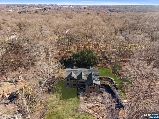 a view of a brick house with a swimming pool next to a yard