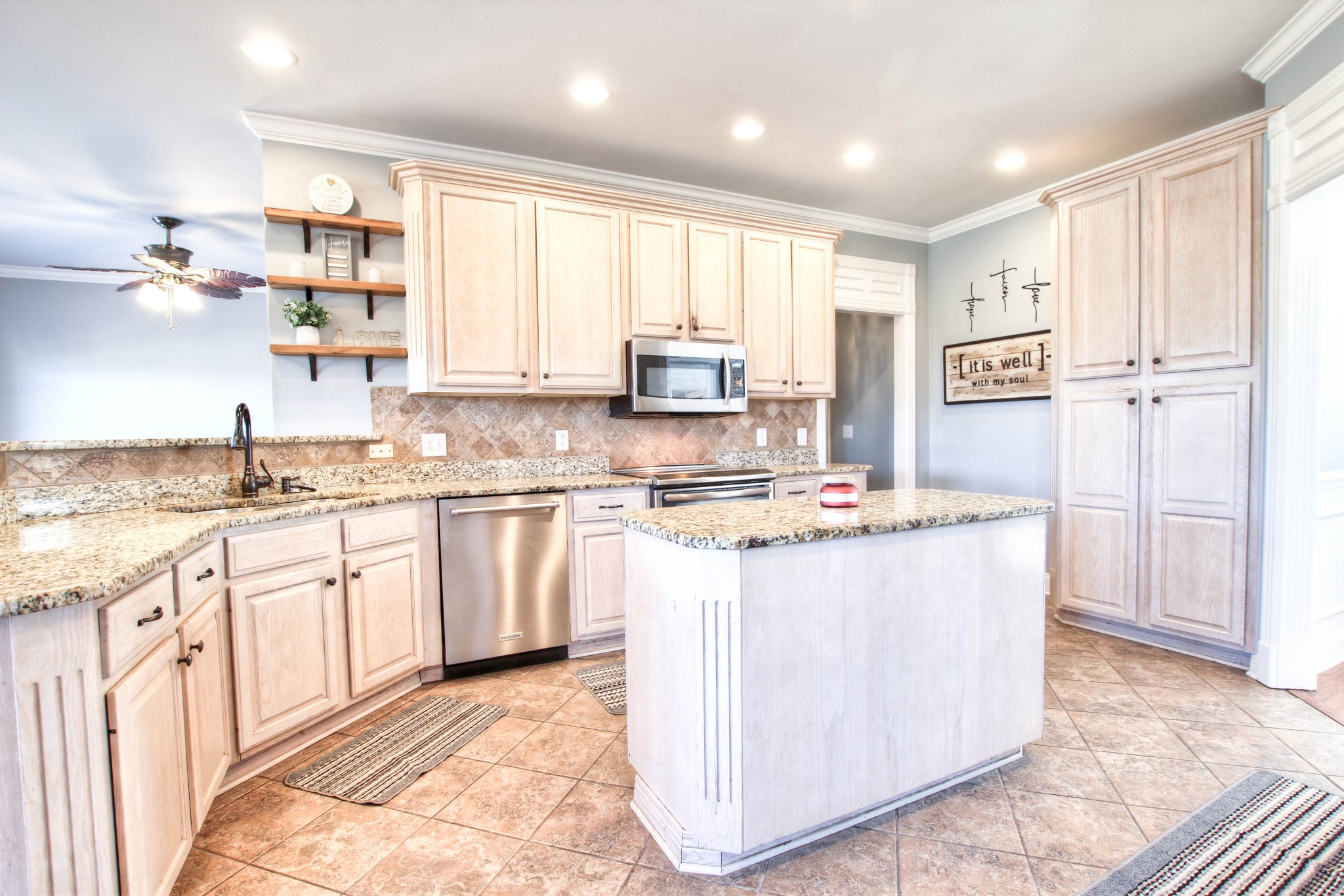 805 Peconic Place Murfreesboro, TN 37130 - Photo 7 of 36 a kitchen with kitchen island granite countertop a stove top oven a sink a counter space and cabinets