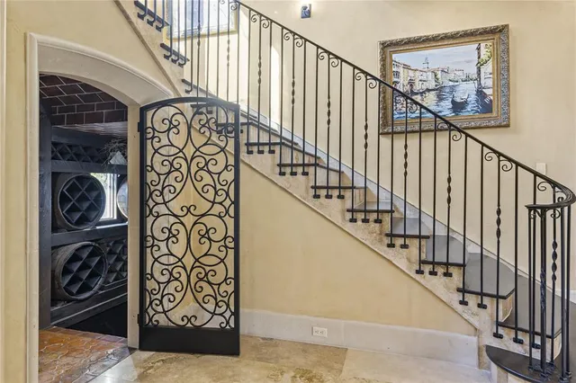 an aerial view of a house with a yard and a large tree