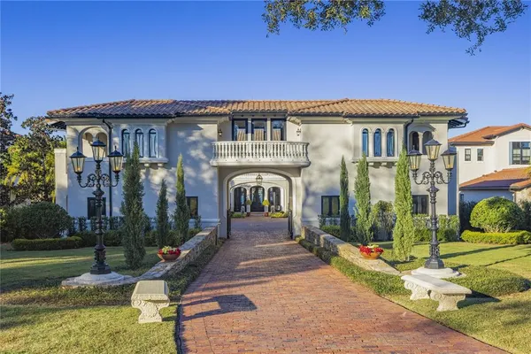 a view of a house with backyard porch and sitting area