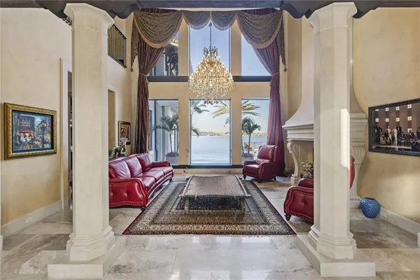 a living room with a couch and a chandelier