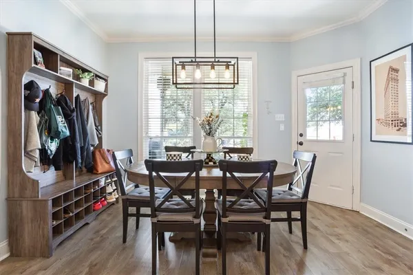 a view of a dining room with furniture window and wooden floor