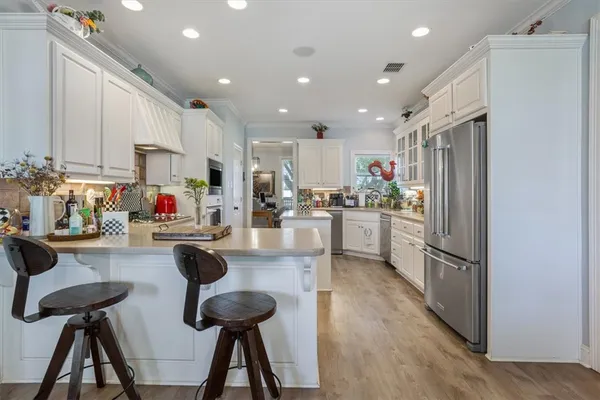 a kitchen with stainless steel appliances granite countertop a refrigerator sink and cabinets