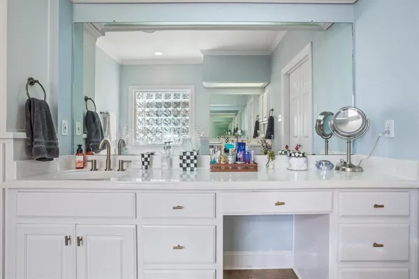 a bathroom with a tub sink and mirror