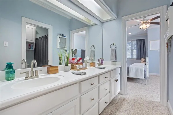 a bathroom with shower and mirror