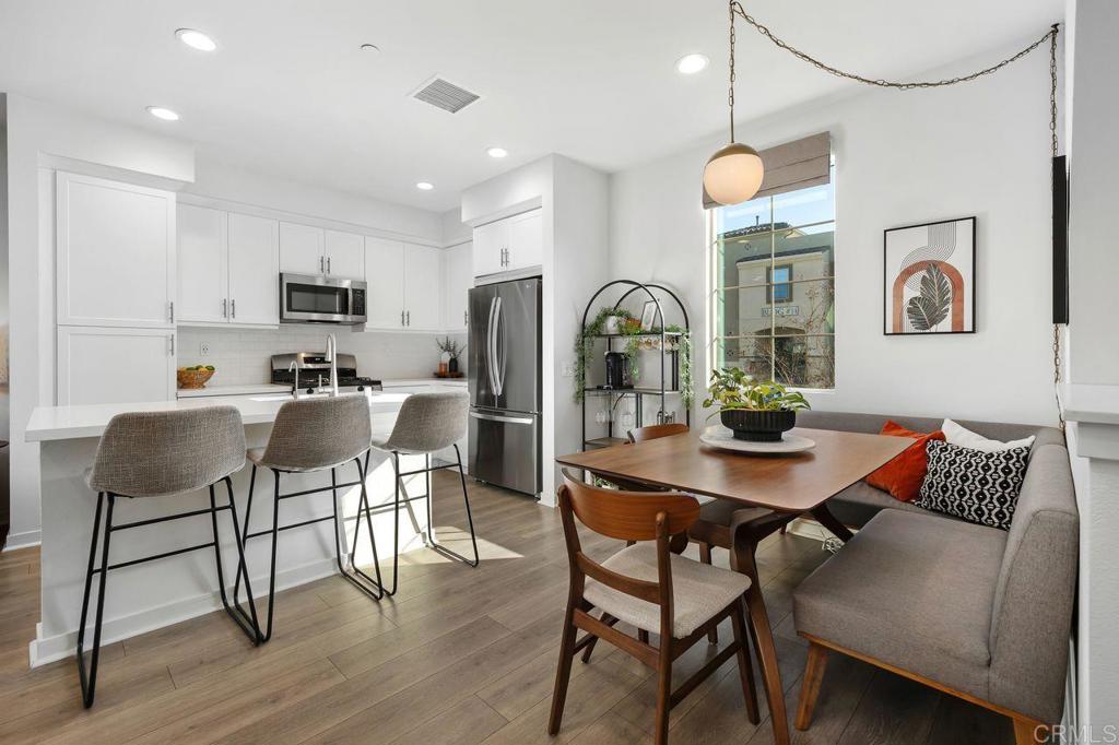 a view of a dining room with furniture and wooden floor