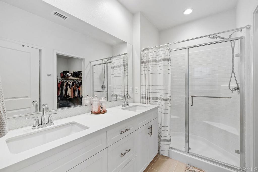 305 Cricket Court Santee, CA 92071 - Photo 12 of 25 a bathroom with a double vanity sink mirror double shower
