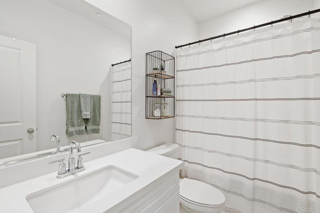 305 Cricket Court Santee, CA 92071 - Photo 14 of 25 a bathroom with a sink toilet and shower
