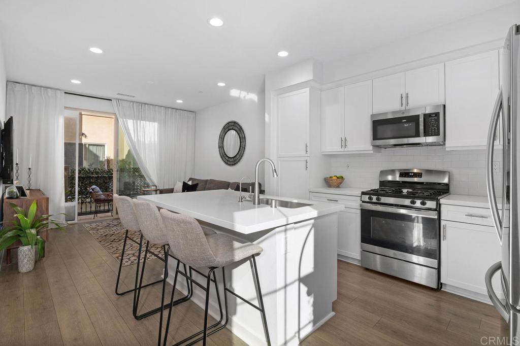 305 Cricket Court Santee, CA 92071 - Photo 3 of 25 a kitchen with a stove a sink and a refrigerator