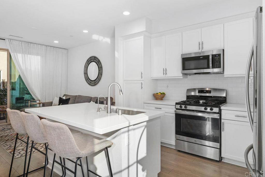 305 Cricket Court Santee, CA 92071 - Photo 5 of 25 a kitchen with a stove a sink and a microwave