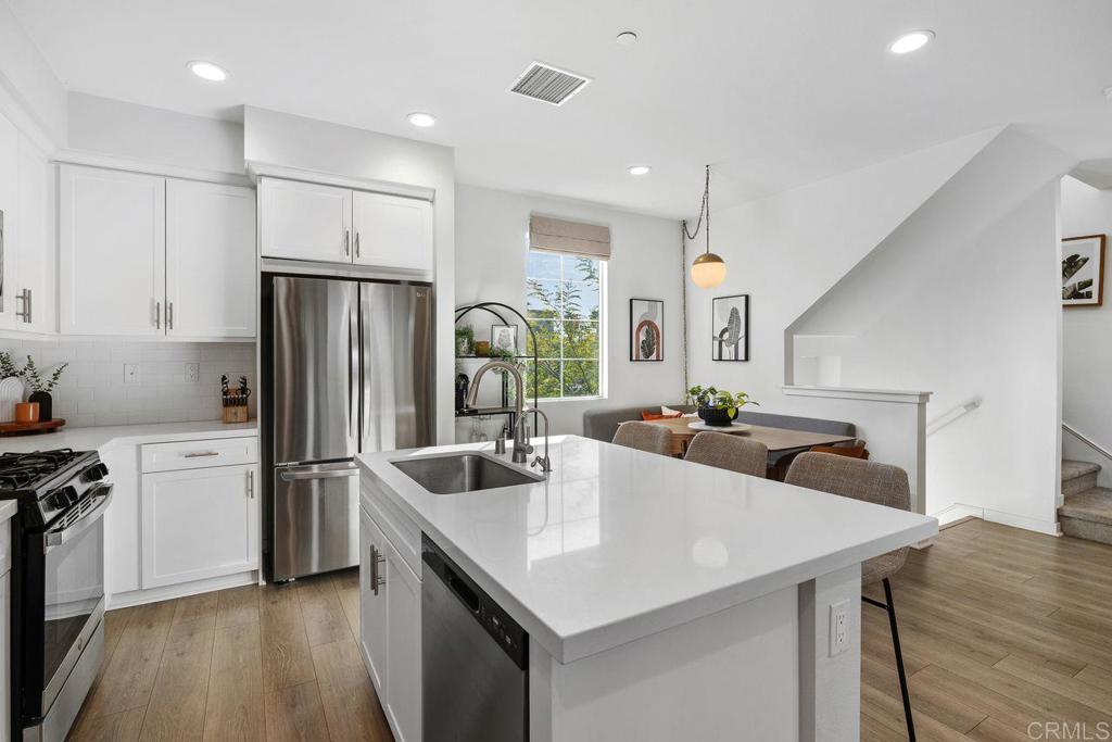 305 Cricket Court Santee, CA 92071 - Photo 6 of 25 a kitchen with refrigerator and a sink
