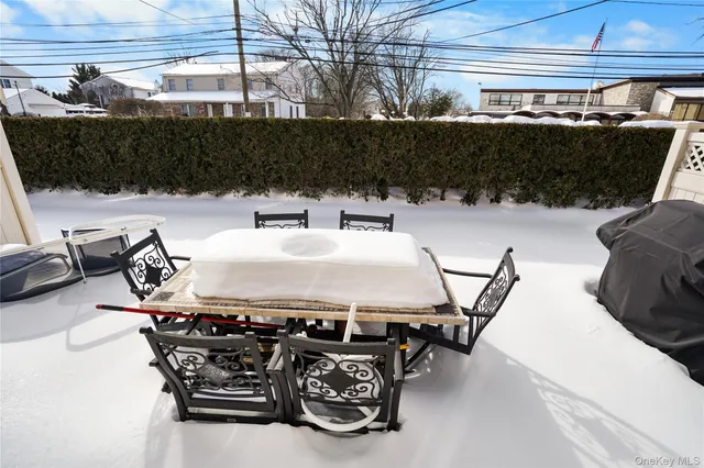 a roof deck with table and chairs