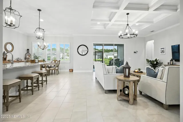 a living room with lots of furniture and view of chandelier