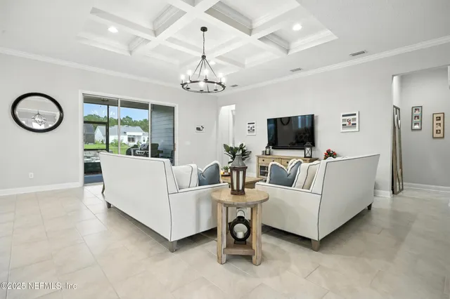 a living room with furniture a flat screen tv and a large window