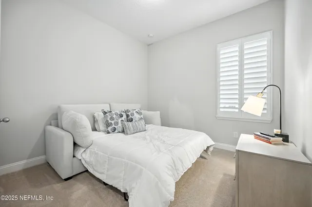 a bedroom with a bed and a lamp