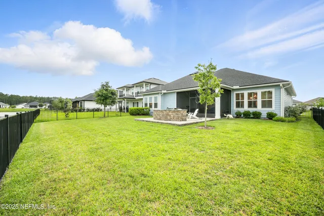 a front view of house with a garden
