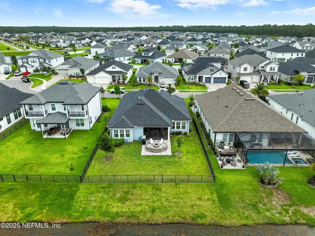 an aerial view of a house with a garden potted plants and large trees