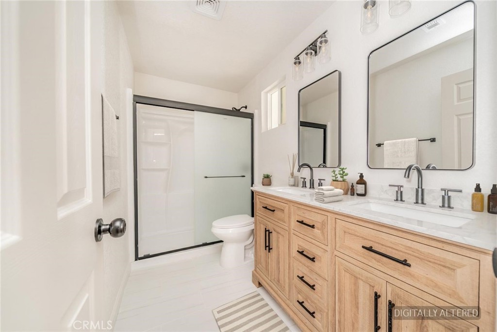 14387 Jicarilla Road Apple Valley, CA 92307 - Photo 18 of 24 Remodeled Primary Bathroom (Disclaimer: Some images have been digitally enhanced with virtual staging to illustrate potential room layouts and furnishings. Actual property condition and features may vary. Buyer to verify all information independently).