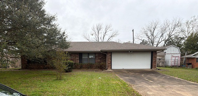a front view of a house with a garden and trees