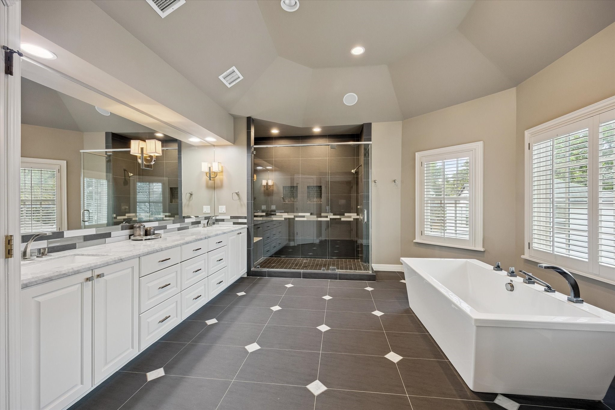 6358 Auden Street Houston, TX 77005 - Photo 23 of 50 a large bathroom with a large tub sink shower and mirror