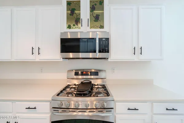 a stove top oven sitting inside of a kitchen