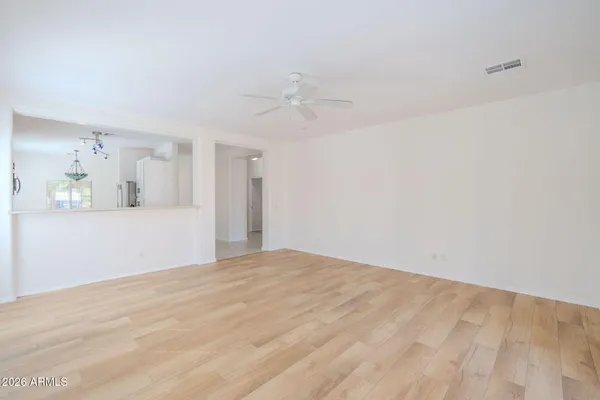 a view of empty room with fan and window