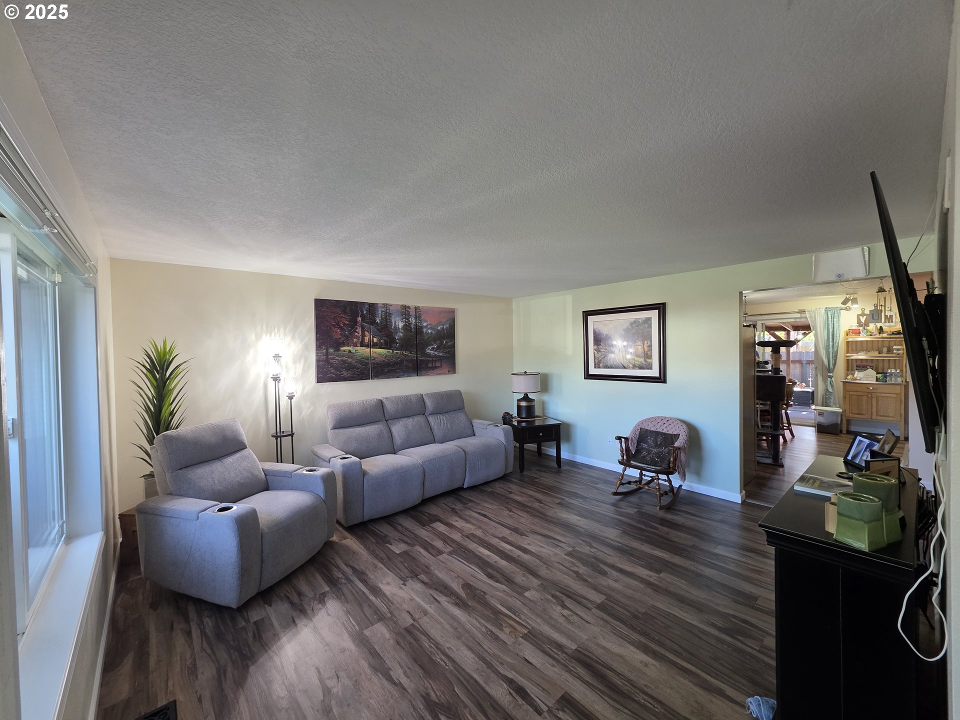413 Southeast 8th Street Battle Ground, WA 98604 - Photo 11 of 18 a living room with furniture a couch and a flat screen tv