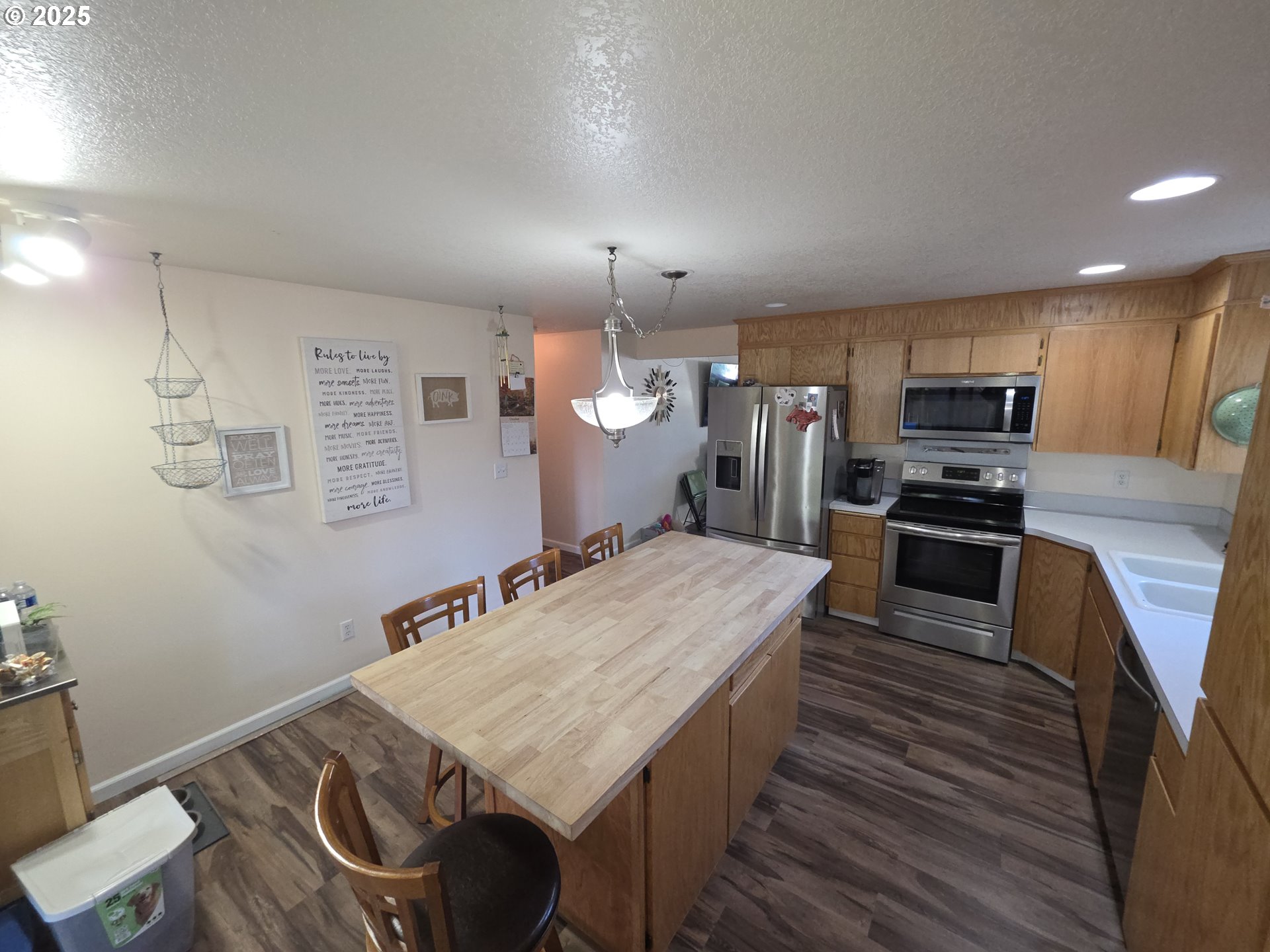413 Southeast 8th Street Battle Ground, WA 98604 - Photo 13 of 18 a kitchen with granite countertop a stove and cabinets