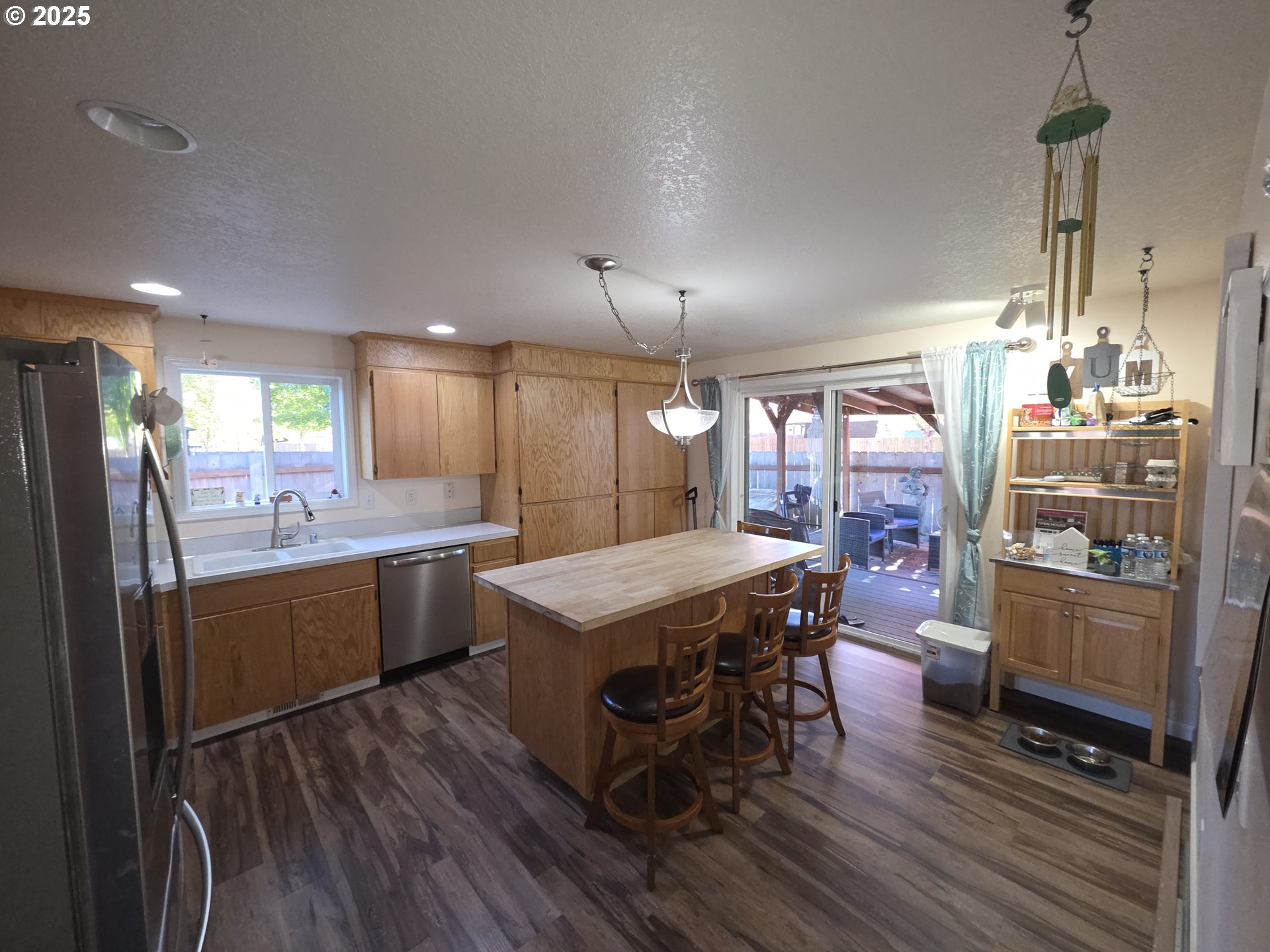 413 Southeast 8th Street Battle Ground, WA 98604 - Photo 14 of 18 a kitchen with stainless steel appliances granite countertop a kitchen island hardwood floor sink stove dining table and chairs
