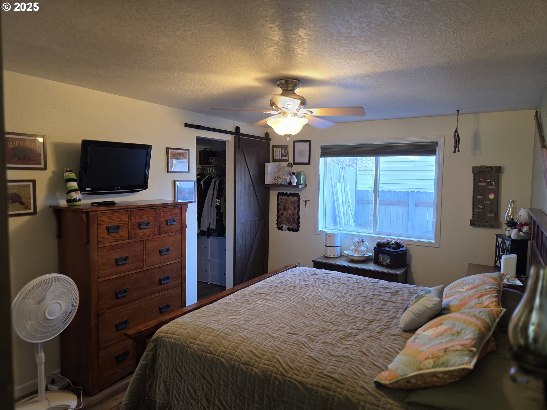 413 Southeast 8th Street Battle Ground, WA 98604 - Photo 18 of 18 a bedroom with a bed and a flat tv screen on dresser