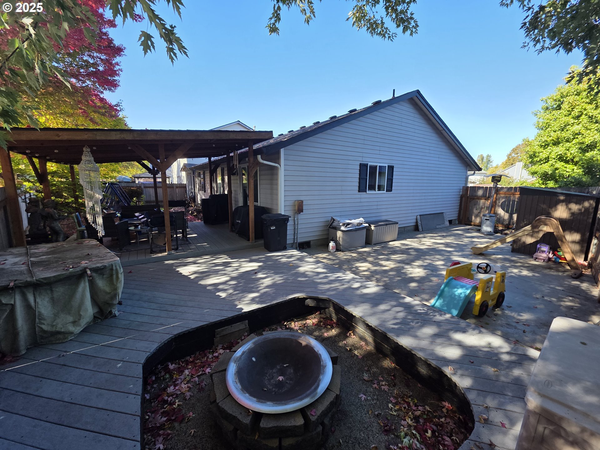 413 Southeast 8th Street Battle Ground, WA 98604 - Photo 4 of 18 a backyard of a house with barbeque oven table and chairs